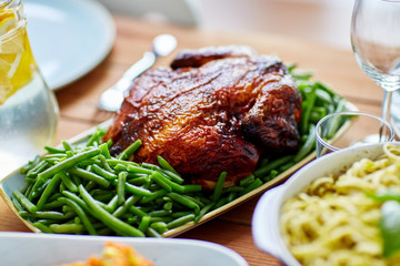 roast chicken with garnish of green peas on table