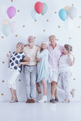 Senior friends with colorful balloons
