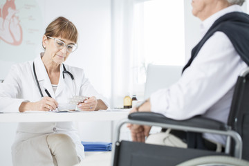 Specialist woman and disabled patient