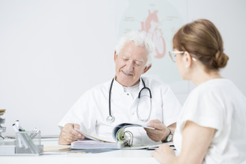 Smiling senior surgeon and patient