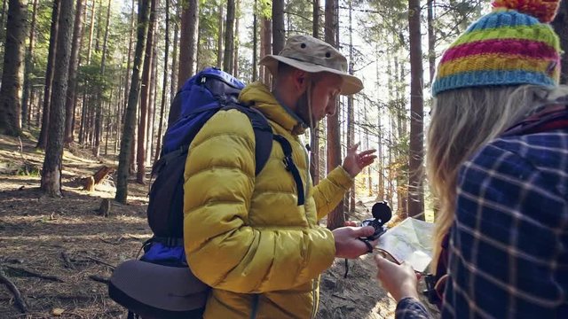 Travelers looking at map while hiking