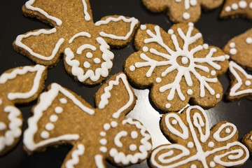 Decorated candy gingerbread with sugar topping white on plate.