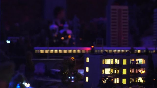 Train at night through the city with lights bokeh in slow motion changes focus. 3840x2160