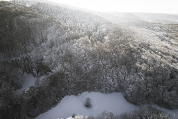 Aerial winterwonderland view with drone of snowy forest in Lower Austria