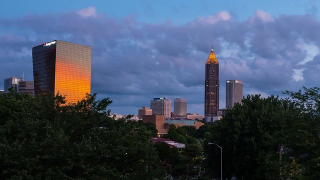 Atlanta, USA. Time-lapse of Midtown in Atlanta, USA night to day. Fast pacing clouds over the Bank of America Plaza in the morning. Zoom out