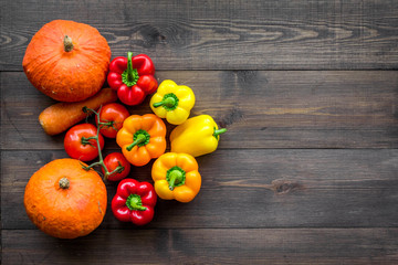 Healthy meal with fiber. Fresh vegetables pumpkin, carrot, paprika, tomatoes on dark wooden background top view copyspace