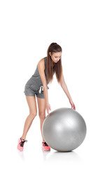 woman in sports clothes with fitness ball