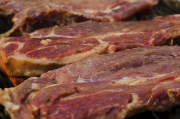 Baking fresh meat on grill closeup