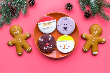 New Year Eve's recipes. Gingerbread cookies with confictionery glaze near spruce branch on white background top view