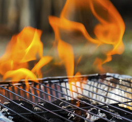 Burning flames and barbecue closeup