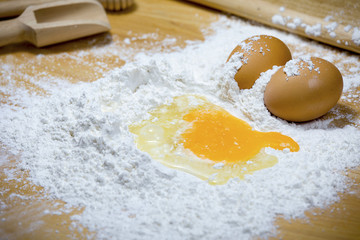 Flour for the dough on a wooden table