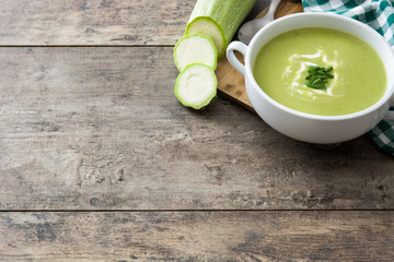 zucchini soup in bowl on wooden table . Copyspace