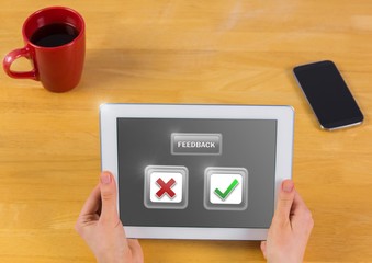 Hands holding tablet with feedback buttons