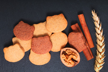 Food concept Spot focus fresh bake homemade organic Butter sugar cookies two tone cat shape on black slate stone plate with copy space