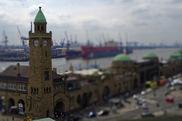 Fototapeta na wymiar historischer Hafen in Hamburg mit Schiffen und Docks im Hintergrund und Hafenanlage mit Glockenturm in Deutschland Europa