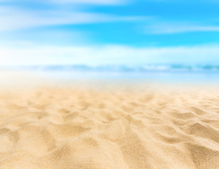 Fototapeta na wymiar Sandy beach with blurry blue ocean