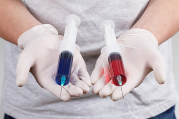 Hand with syringes, ready for narcotic injection