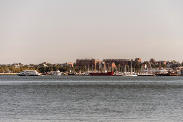 Obraz premium View of harbor from the Boston Waterfront with fishing boat trucks and boats anchored Massachusets