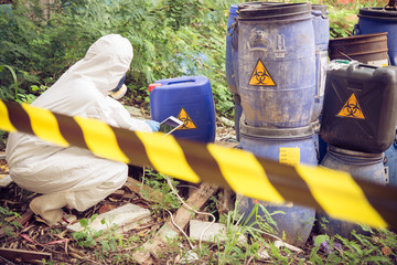 Asian scientist wear Chemical protection suit check danger chemical,working at dangerous...
