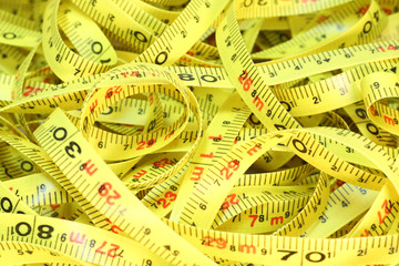 Group of tape measures on a white background.