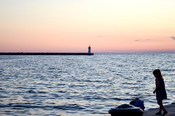 A young couple dreaming at the Adriatic beach in Porec, Croatia, on sunset