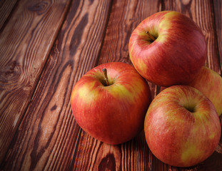 Fresh, ripe apples on an old wooden table. Fruit to comply with the diet