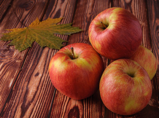 Fresh, ripe apples on an old wooden table. Fruit to comply with the diet