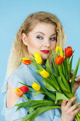 Pretty woman with red yellow tulips bunch