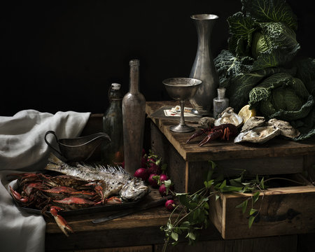 Seafood and rustic utensil arranged on wooden table