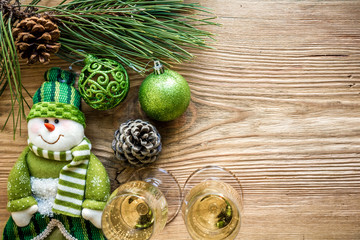 New Year's holiday with spruce branches and with a pair of wine glasses of champagne. Flat lay, top view, copy space