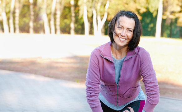 Mature Woman Runner Taking A Rest After Running In The Park