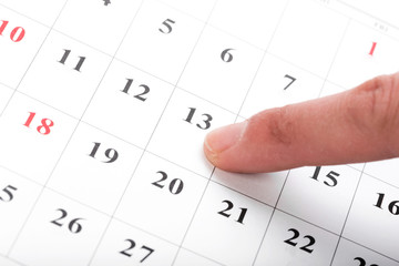 Check out the dates in a business calendar concept