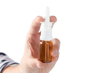 Nasal spray in a human hand isolated on white background