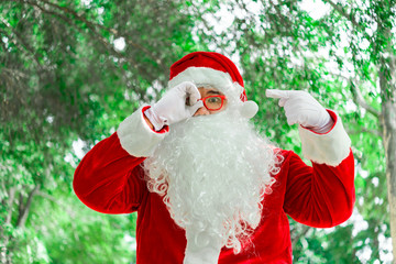 Portrait of santa claus on bokeh light under tree,Thailand people,Sent happiness for children,Merry christmas,Welcome to winter