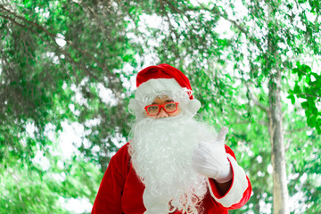 Portrait of santa claus on bokeh light under tree,Thailand people,Sent happiness for children,Merry christmas,Welcome to winter