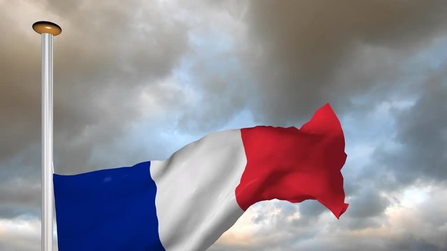 The flag of France up on background a cloudy sky