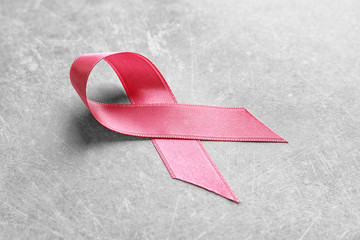 Pink ribbon on grey background. Breast cancer awareness concept
