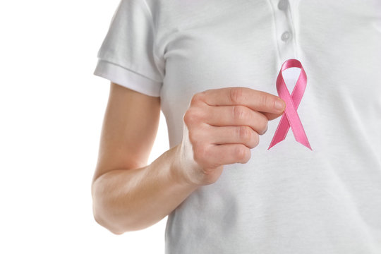 Woman holding pink ribbon on white background. Breast cancer awareness concept