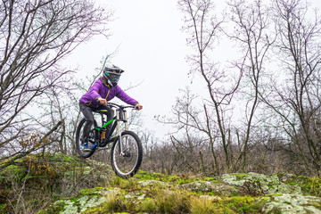 Enduro Cyclist Riding the Mountain Bike on the Rocky Trail.