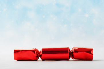 Red Christmas Cracker with Star Spangled Snowfall Background