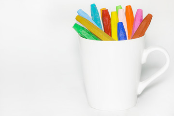 Color Crayons In A glass on white background.