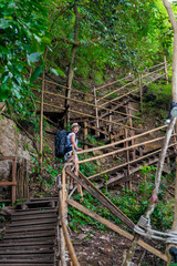 a staircase leading uphill and a tourist with a backpack on the stairs