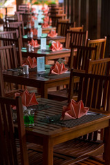 rows of café tables on the veranda with nice napkins there are no people