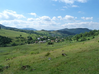 Fototapeta na wymiar The landscape of the mountain village Volovets, surrounded by the Carpathian Mountains.