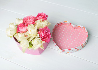 Heart of roses on a wooden white background. The concept for the Valentine's Day