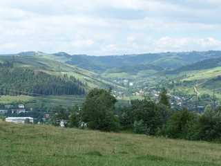 Fototapeta na wymiar The landscape of the mountain village Volovets, surrounded by the Carpathian Mountains.