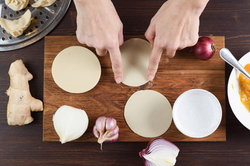Making Asian steam dumplings on wooden table