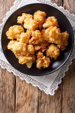 fried fresh cauliflower in breadcrumbs closeup. Vertical top view