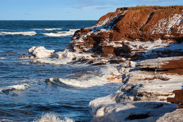Winter waves roll in along the shoreline of rural Prince Edward Island, Canada.