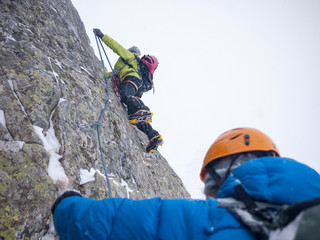 Mountaineers on an extreme winter climb. West Alps, Europe. Concepts: risk, strength, courage, teamwork.